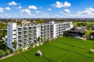 an aerial view of a white building with a green lawn at d'primahotel Petitenget Seminyak 2 in Seminyak