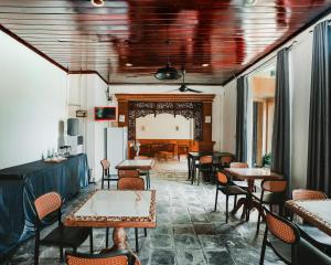 a restaurant with tables and chairs and a dining room at Natasya Kuta Beach Hotel in Kuta