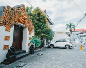 a car parked in front of a building at Natasya Kuta Beach Hotel in Kuta