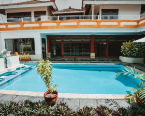 a swimming pool in front of a house at Natasya Kuta Beach Hotel in Kuta +176 photos