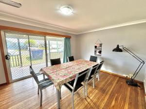 a dining room with a table and chairs at Sunshine on Heath -Pet Friendly in Evans Head