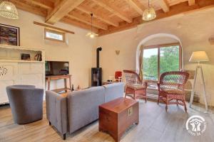 a living room with a couch and chairs at L'abri de la chouette in Langonnet