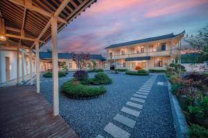 an exterior view of a house with a courtyard at Zhangjiajie The Brookside Hotel& Tianmen National Forest Park & Free pick up service in Zhangjiajie