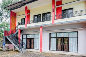 a building with a staircase and windows at RedDoorz @ Gerbang Dieng Plateau Area in Wonosobo