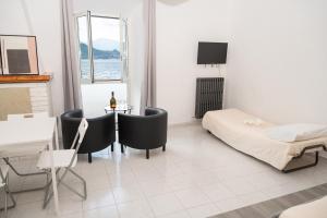 a room with a bed and a table and chairs at Sognando Varenna-Lake Como View- in Fiumelatte