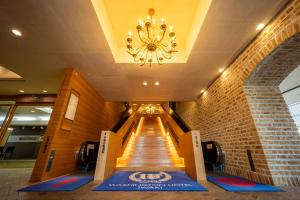 a long hallway with a chandelier in a building at Iwaki Washington Hotel in Iwaki +60 photos