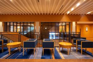 a lobby with chairs and tables in a building at Iwaki Washington Hotel in Iwaki