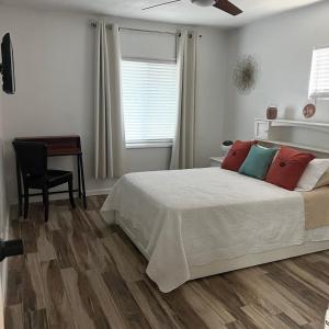 a bedroom with a bed and a table and a chair at West Mitchell in Phoenix