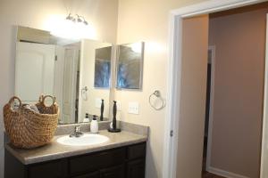 a bathroom with a sink and a mirror at Regatta Getaway in Fayetteville +4 photos