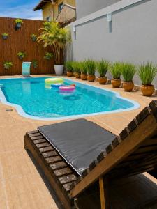 a swimming pool with two frisbees in it at Pousada Recanto do Cowboy in Penha
