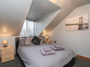 a bedroom with a bed with two towels on it at Fortunatus in Whitby