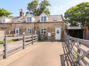 a house with a fence and a gate at Fortunatus in Whitby