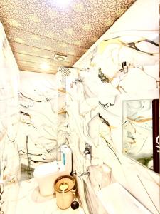 a bathroom with white walls and a toilet in it at Shiv Dham Palace in Varanasi