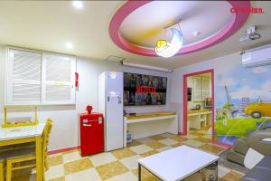 a room with a red refrigerator and a table at 호텔사랑 in Cheonan