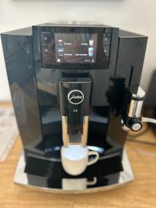 a coffee maker with a cup on a table at Palava Holiday House in Šakvice +11 photos