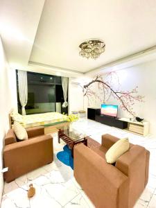 a living room with two couches and a bed at Cat Lai Garden Villa in Ho Chi Minh City