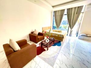 a living room with a couch and a table at Cat Lai Garden Villa in Ho Chi Minh City