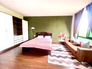 a bedroom with a bed and a couch at Cat Lai Garden Villa in Ho Chi Minh City +10 photos