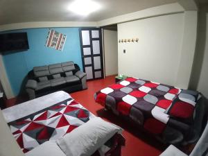 a living room with a bed and a couch at Chepe de mi Corazon in Abancay