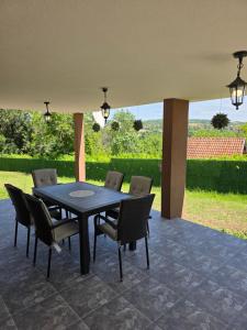 a black table and chairs on a patio at Vila Mila in Vlaška