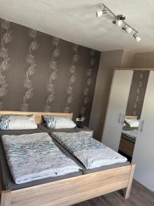 a bedroom with two beds and a mirror at Philippsburg in Monreal