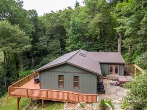 a house with a deck in the woods at Snaggys Retreat in Boone