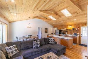 a living room with a couch and a kitchen at Snaggys Retreat in Boone