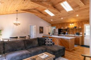 a living room with a couch and a kitchen at Snaggys Retreat in Boone +25 photos