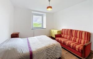 a bedroom with a bed and a red couch at Elegant Apprt in Lachamp-Raphaël