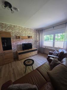 a living room with a couch and a flat screen tv at Haus Thieke in Rhederfeld