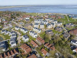 an aerial view of a town with houses and the water at Ferienhaus Lillys Beachhouse in Varel