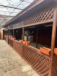 a building with a fence with orange containers on it at Vila Coralia in Schitul