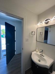 a bathroom with a sink and a mirror at Stampeder Inn in Williams Lake +88 photos