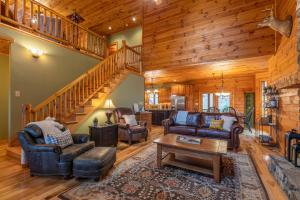 a living room with couches and a staircase at The Forge in Lansing