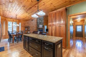 a kitchen and dining room with a table in a log home at The Forge in Lansing +31 photos