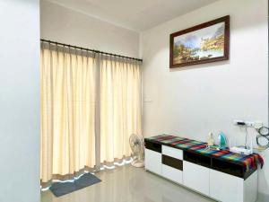 a white room with a table and a window at Phala Beach Rayong Palm Villa 2BR2BA in Ban Phala