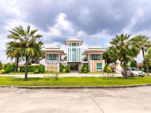 a large house with palm trees in front of it at Phala Beach Rayong Palm Villa 2BR2BA in Ban Phala