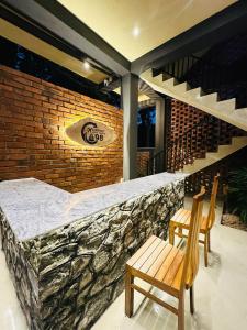 a bar with two chairs and a brick wall at Airport Hotel Transit 98 in Katunayaka