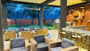 a room with chairs and a bar with a pool at Airport Hotel Transit 98 in Katunayaka +5 photos