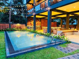 a swimming pool in the yard of a house at Airport Hotel Transit 98 in Katunayaka