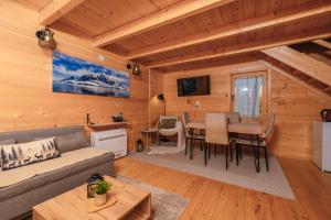 a living room with a couch and a table at Green Top Durmitor in Žabljak