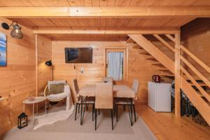 a dining room with a table and chairs in a cabin at Green Top Durmitor in Žabljak