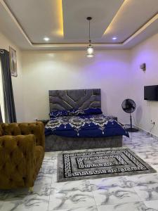 a bedroom with a bed and a couch at Starlight Homes in Asaba