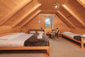 a bedroom with two beds in a log cabin at Green Top Durmitor in Žabljak