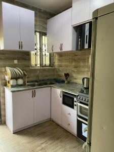 a kitchen with white cabinets and a stove at Starlight Homes in Asaba