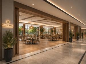 a restaurant with tables and chairs in a building at Khatai Center Hotel in Baku