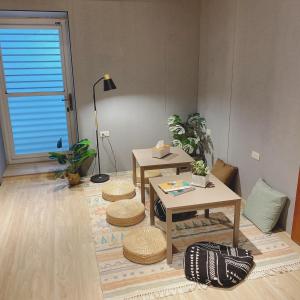 a living room with two tables and two stools at 綠島夏御 微熱海岸 Coast Venus in Green Island