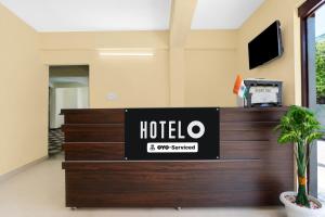 a hotel lobby with a sign on the reception desk at Super Hotel O Kashi Ghat Varanasi Formerly Ganga Valley in Rāmnagar