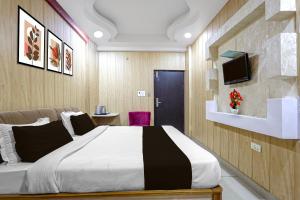 a bedroom with a large bed and a tv at Collection O Charbagh Metro Station Lucknow Formerly Seven Seas in Lucknow