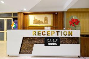a reception desk in a building with a sign at Collection O Charbagh Metro Station Lucknow Formerly Seven Seas in Lucknow